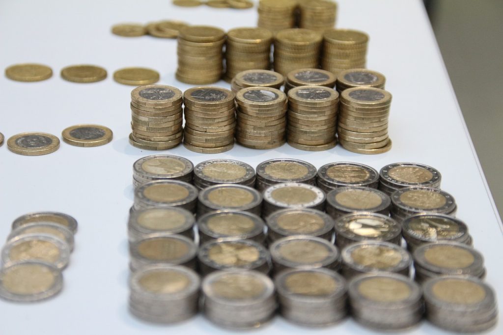 A table displaying two separate piles of coins, highlighting their different sizes and arrangements